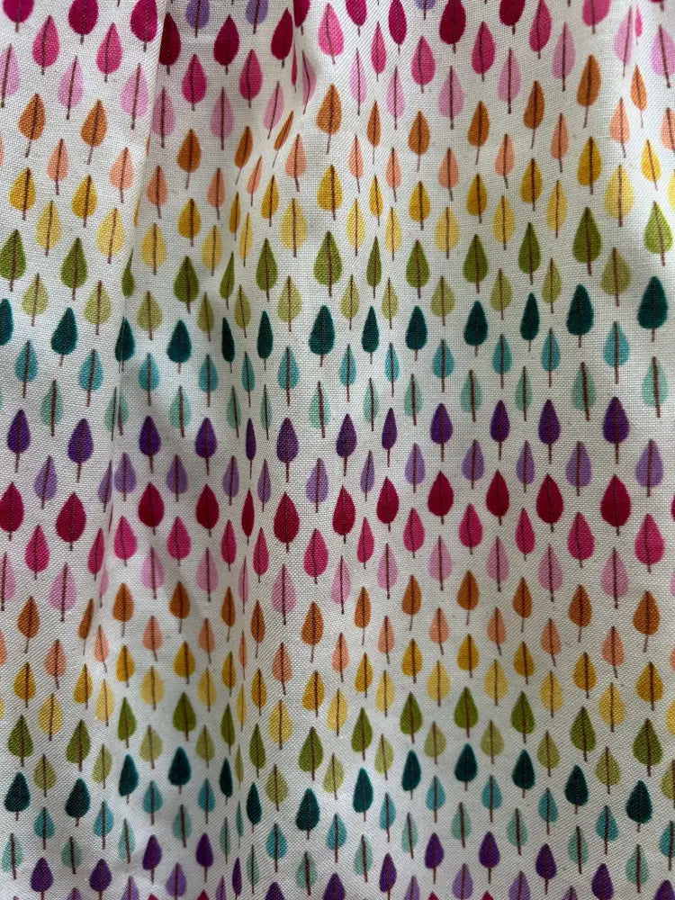 Rainbow drop retro 60s cotton dress with pink peter pan collar featuring vibrant rainbow teardrop leaf pattern on white