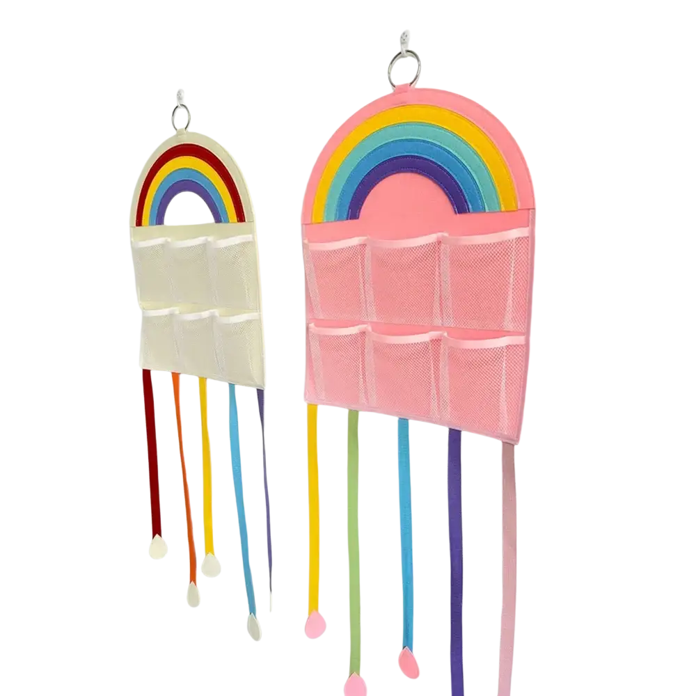 Pink rainbow-themed hair accessory hanging organizer with mesh pockets and colorful ribbon tassels for storage