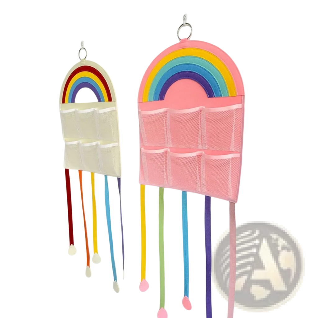 Pink rainbow-themed hair accessory hanging organizer with mesh pockets and colorful ribbon tassels for storage