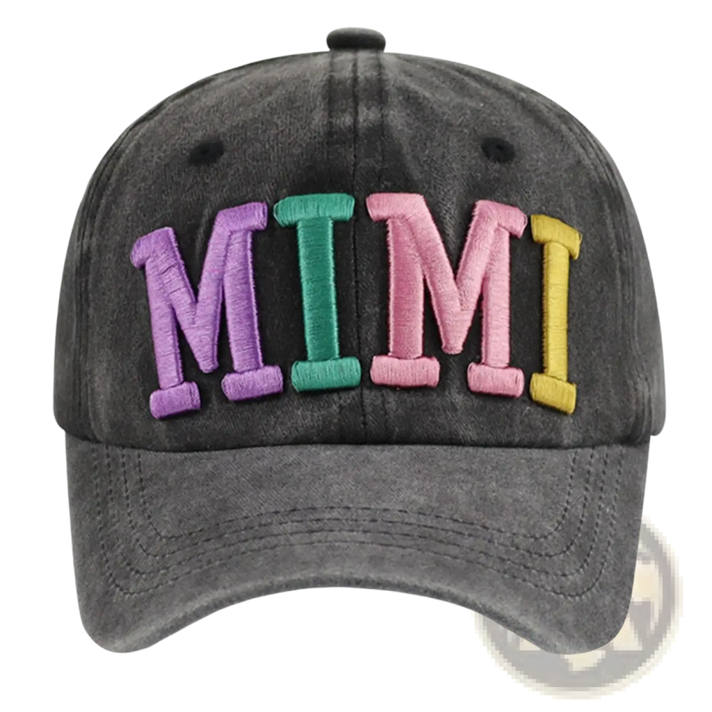 A faded black baseball cap with rainbow colorful mimi embroidered letters in purple green pink and yellow