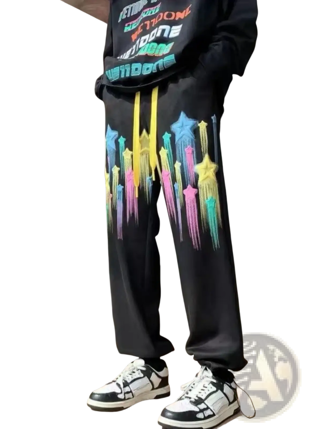 Black men sweatpants with vibrant rainbow star graphics dripping down the legs and bright yellow drawstrings