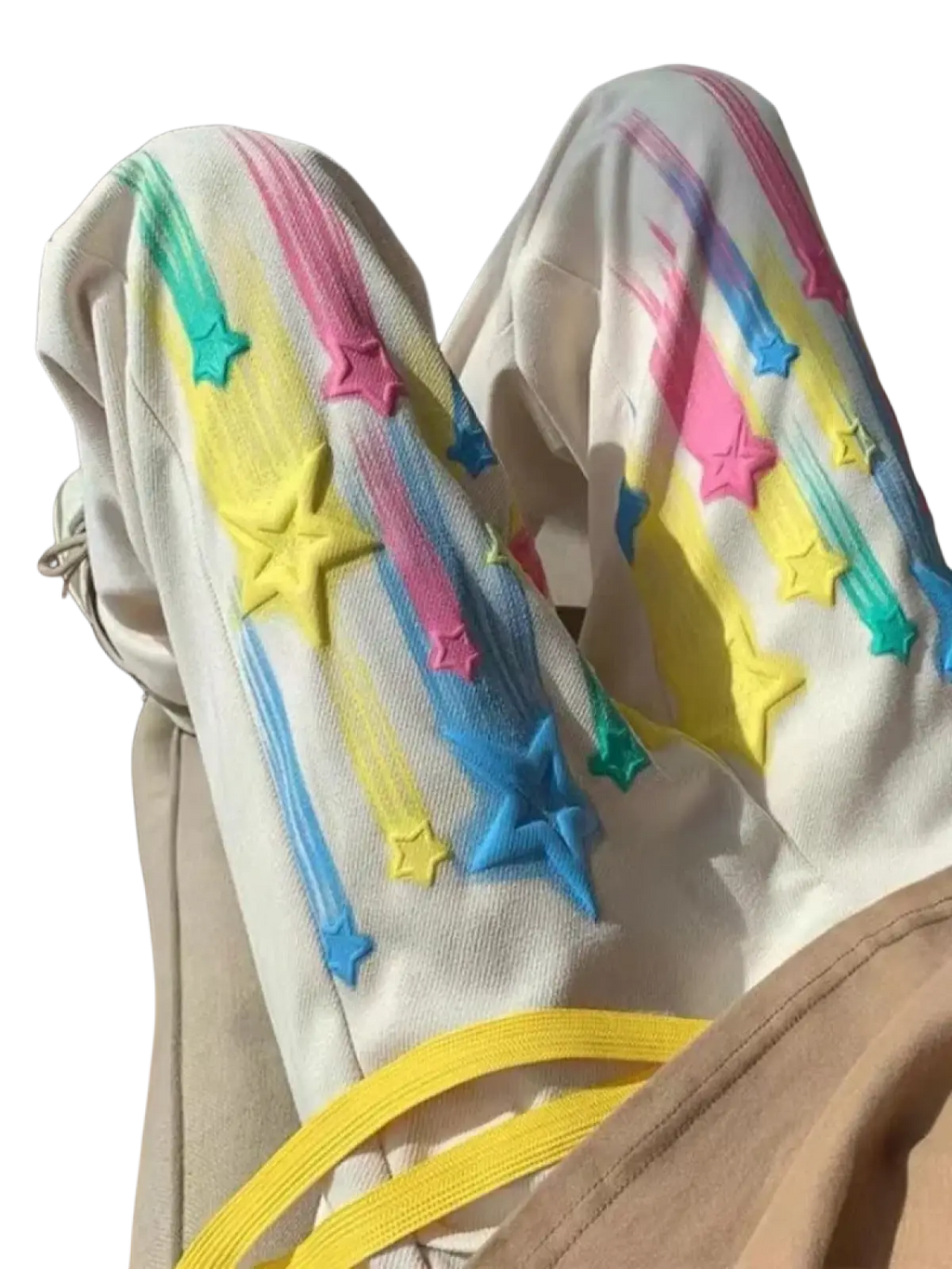 Cream-colored rainbow star graphic men sweatpants with vibrant rainbow star and streak appliqués in pink yellow blue green
