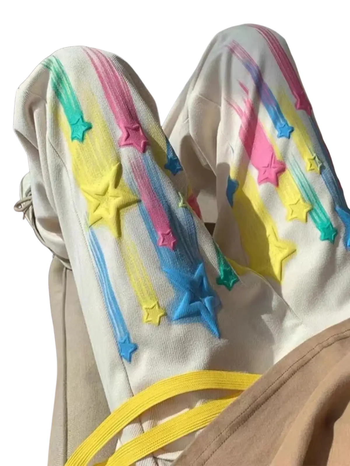 Cream-colored rainbow star graphic men sweatpants with vibrant rainbow star and streak appliqués in pink yellow blue green