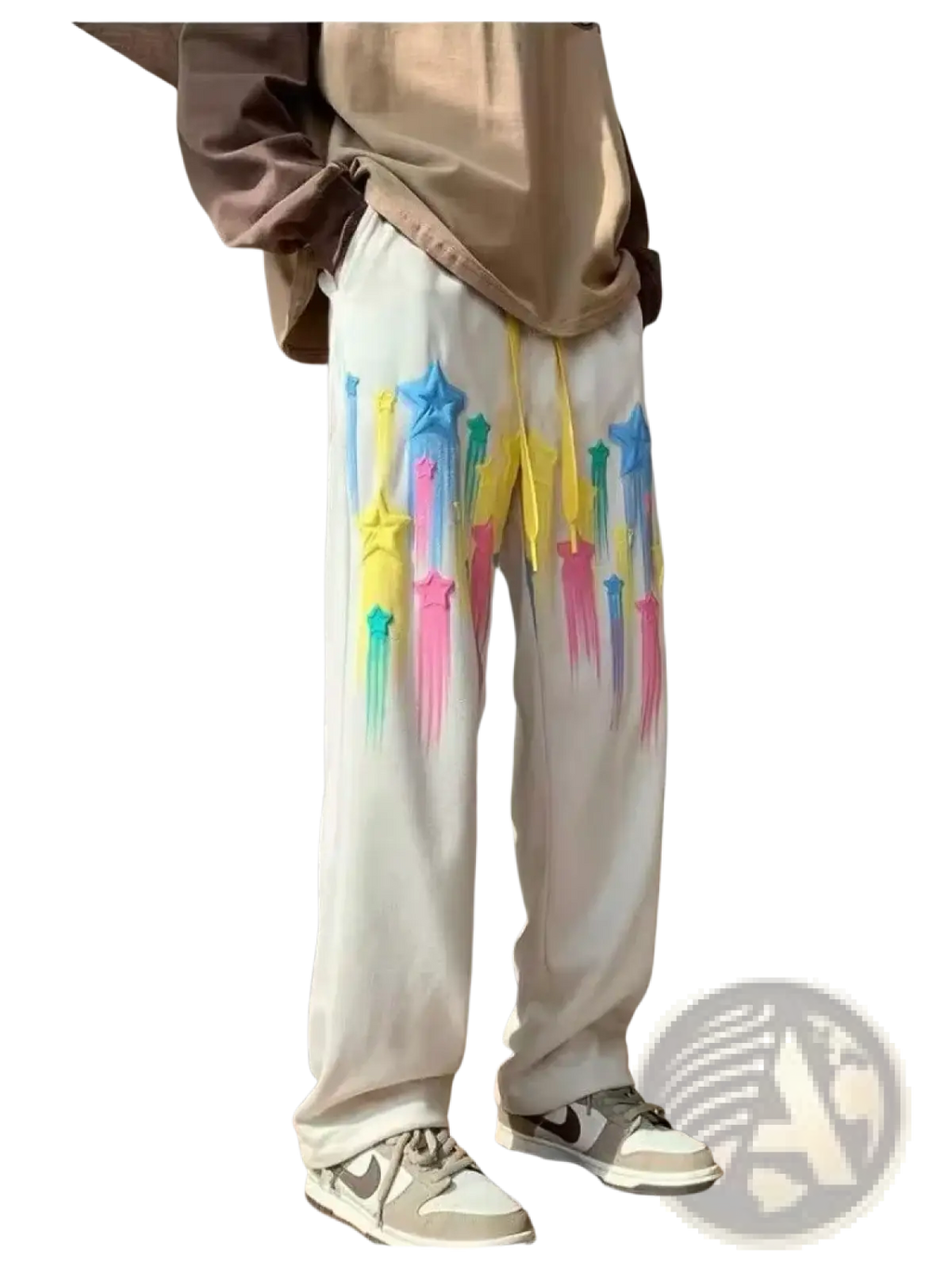 White sweatpants with vibrant dripping rainbow star graphics and yellow drawstrings in a men’s casual style