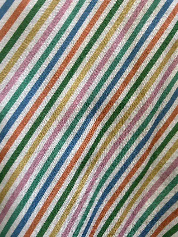 Rainbow stripe vintage cotton skater skirt featuring vibrant diagonal stripes in green orange blue pink and yellow on white