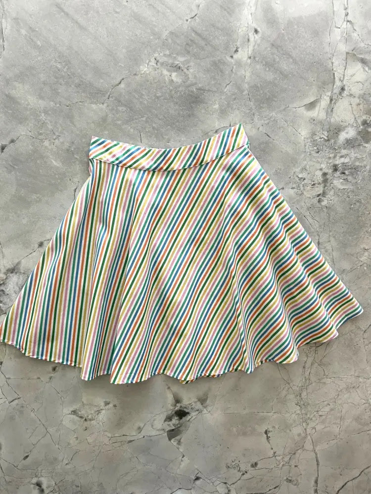 A rainbow stripe vintage cotton skater skirt with vibrant multicolored flared diagonal stripes