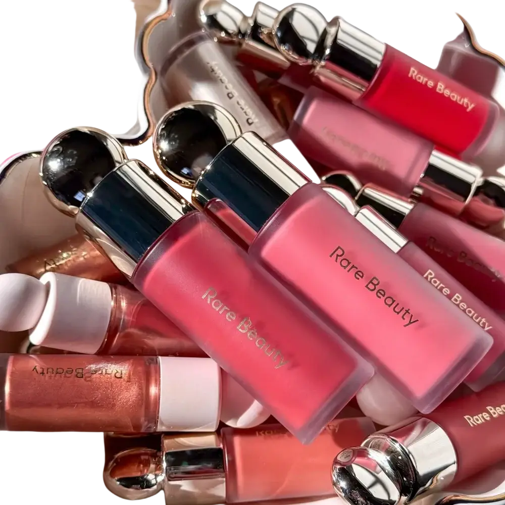 A collection of rare beauty soft pinch liquid blushes in soft pink and peach hues in translucent bottles with metallic caps