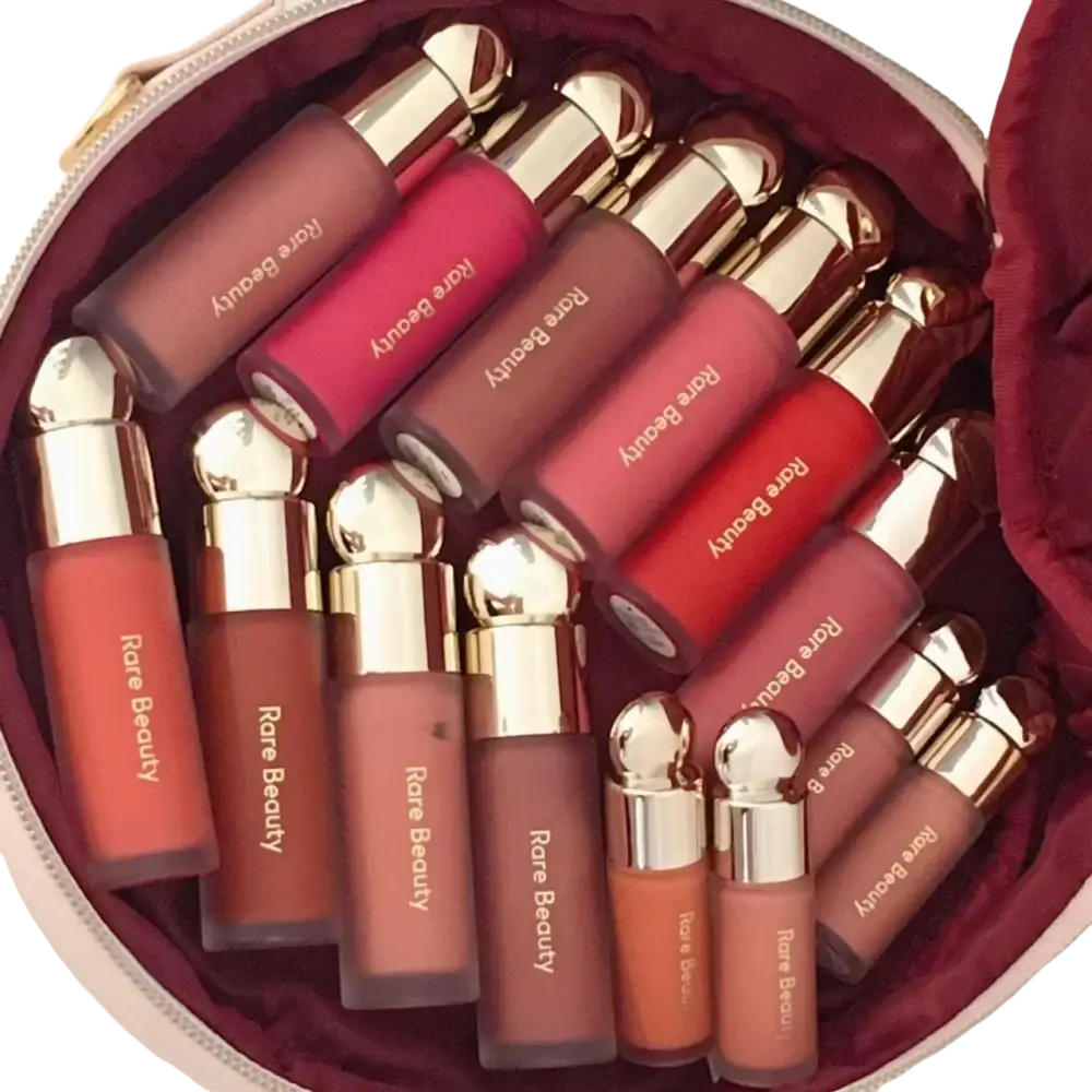 A collection of rare beauty soft pinch liquid blushes in various shades with sleek glass bottles and gold caps