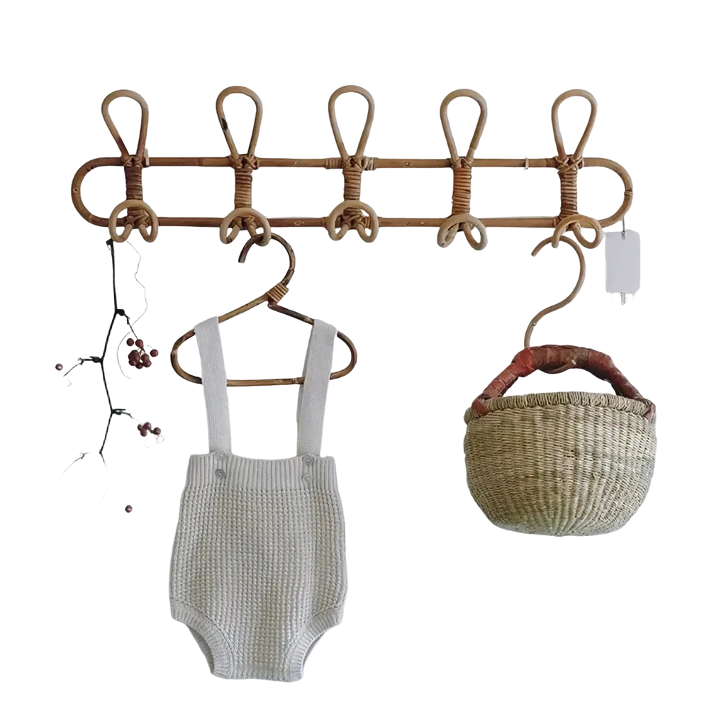 A natural-toned rattan kids wall hook clothing storage rack with five looped hooks for organizing items