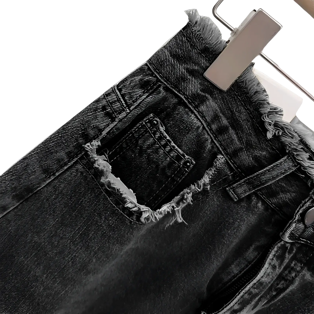 Dark-wash raw edge distressed denim midi skirt with frayed edges and a distressed pocket visible from the back side