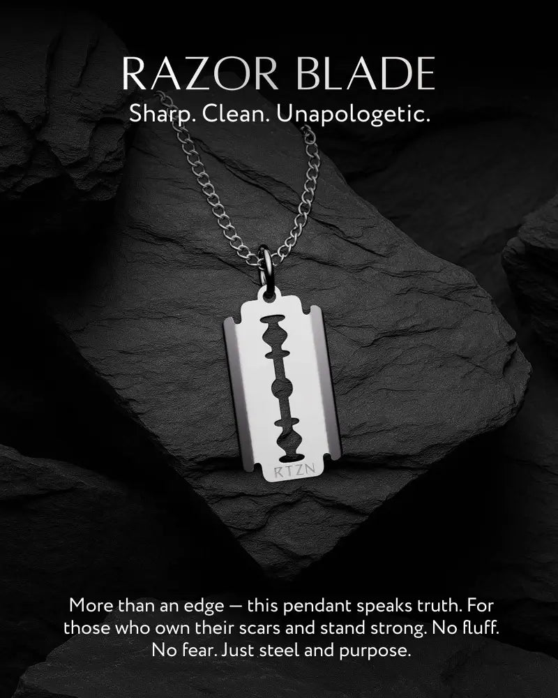 Silver razor blade pendant on stainless steel curb chain necklace with engraved rtzn at the bottom
