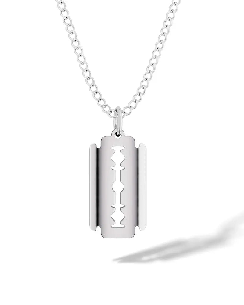 Silver razor blade pendant on a stainless steel curb chain necklace showcasing sleek metal craftsmanship