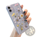 Back side of a real dried flower clear phone case with pressed lavender daisies and yellow flowers in translucent tpu resin