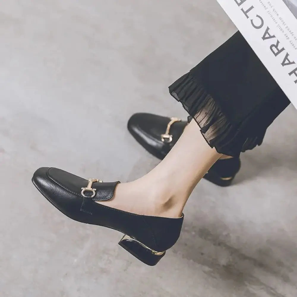 Black leather women’s British style loafers with gold-tone horsebit buckle and low block heel