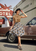 A woman wearing a vintage realistic cat print cotton a-line skirt with pockets paired with a tan polka-dot blouse