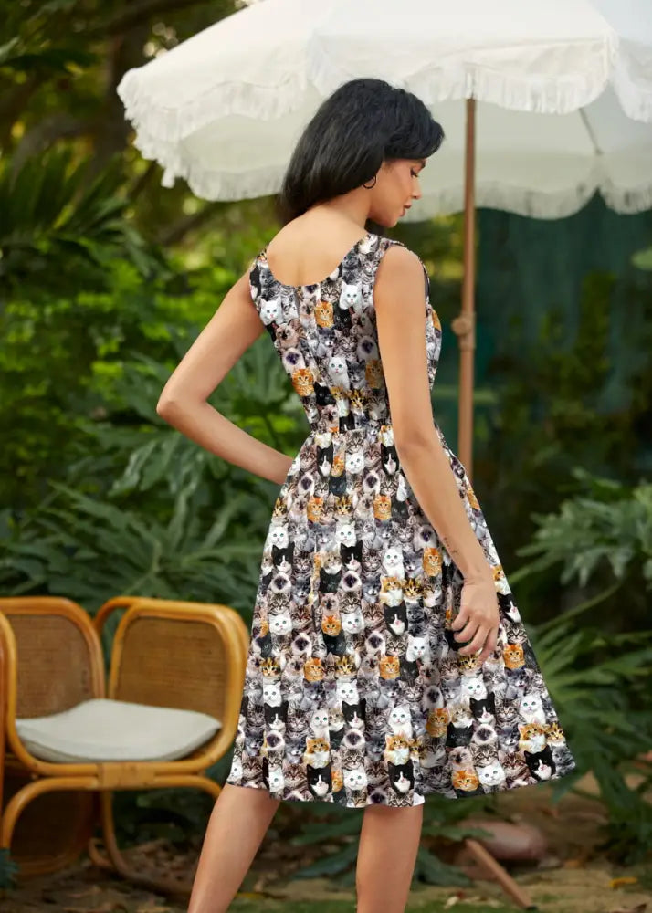 Sleeveless knee-length vintage midi dress with realistic cat face print in black white and orange tones with pockets