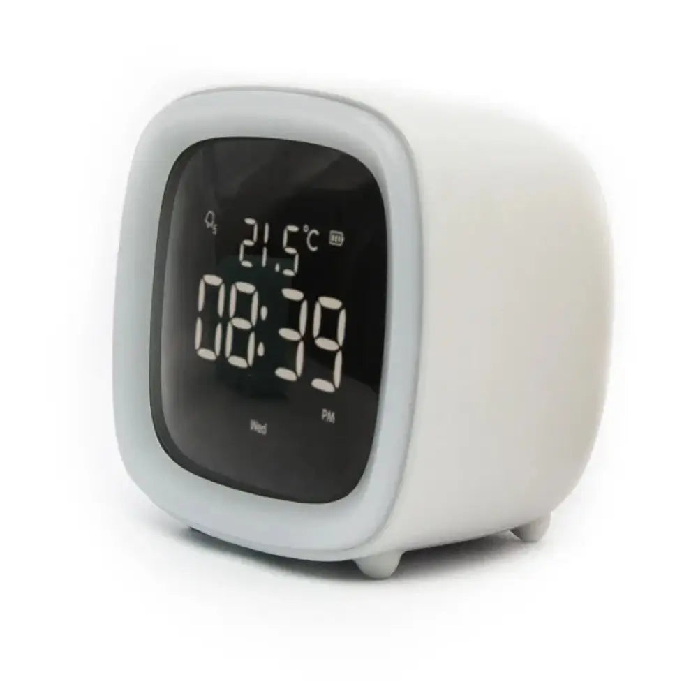 White cube-shaped kids animal digital alarm clock with rounded display showing time temperature and night light
