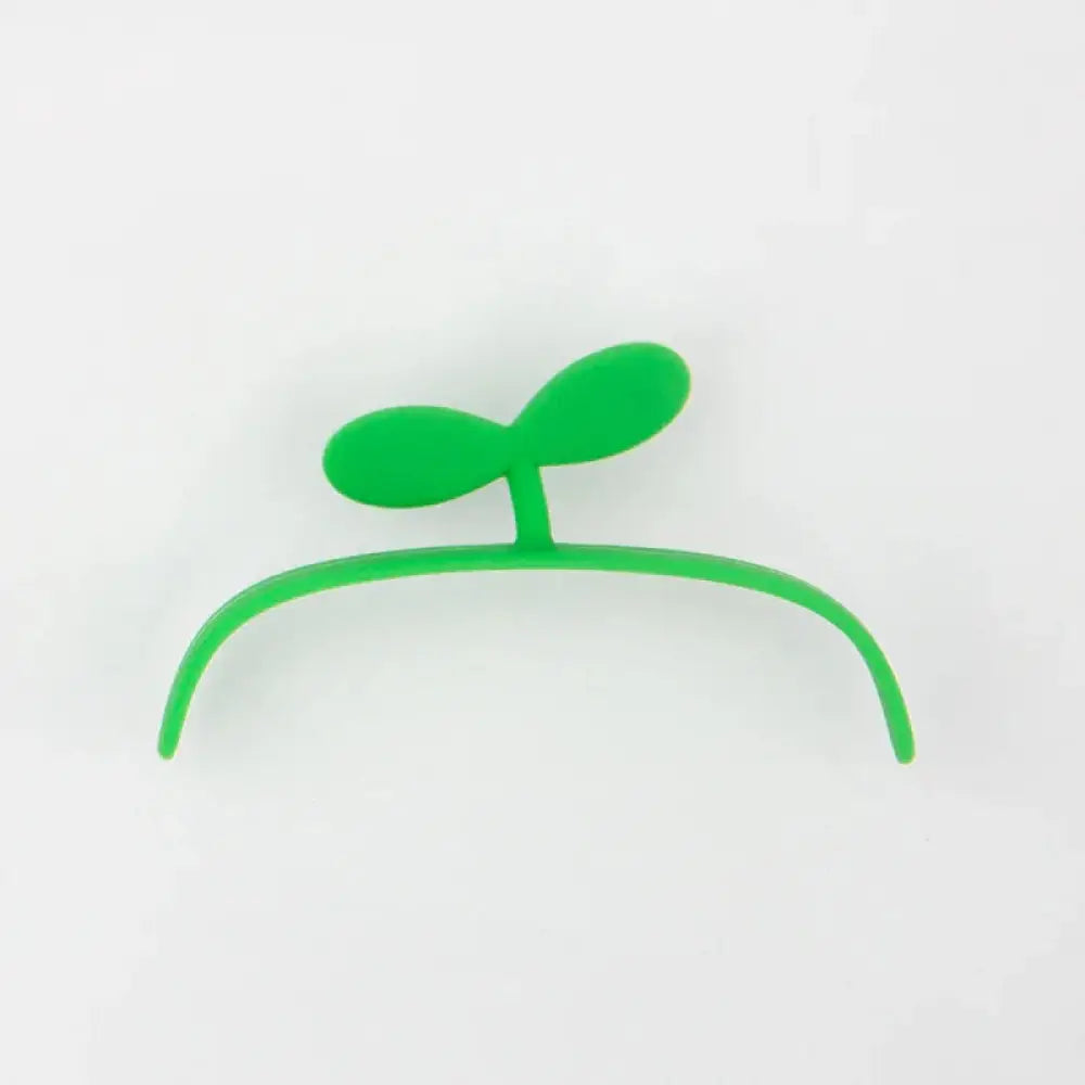 Bright green plastic hair clip shaped like a sprouting plant with two rounded leaves for kids animal digital alarm clock use
