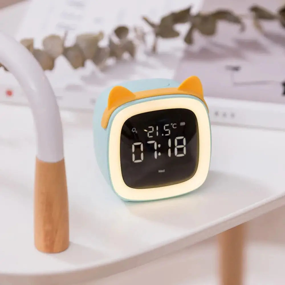 Kids animal digital alarm clock in pastel blue and yellow with cat ears night light and temperature display