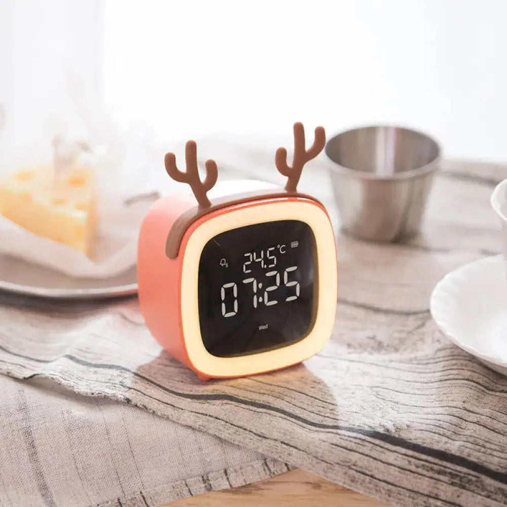 Coral-colored kids animal digital alarm clock with brown antler accents and glowing yellow night light frame