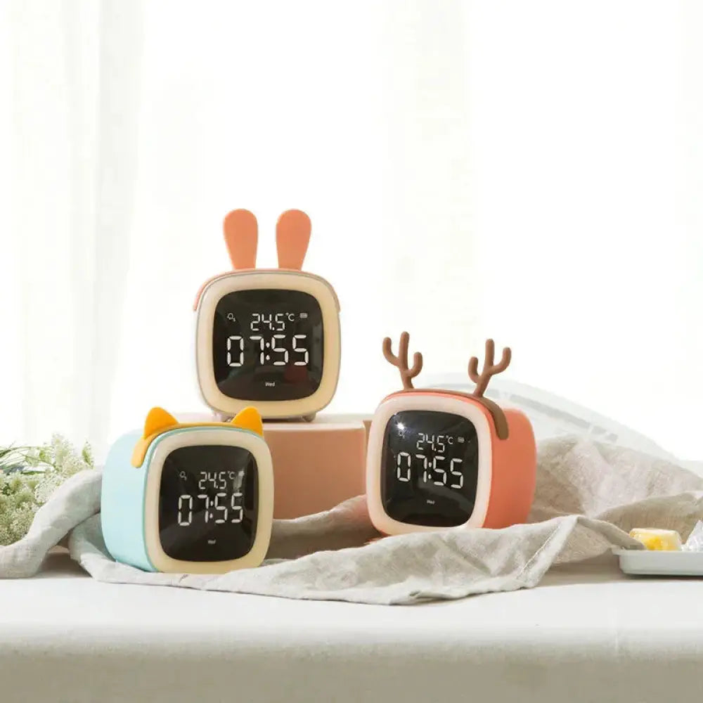 Three pastel kids animal digital alarm clocks with night light temperature feature plastic square bodies with bunny, reindeer, cat ears