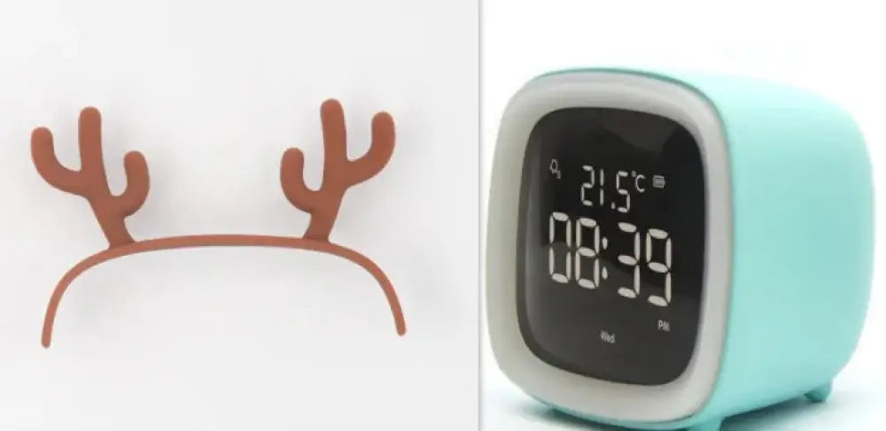 Kids animal digital alarm clock in mint green with white bezel black display showing time and temperature and night light