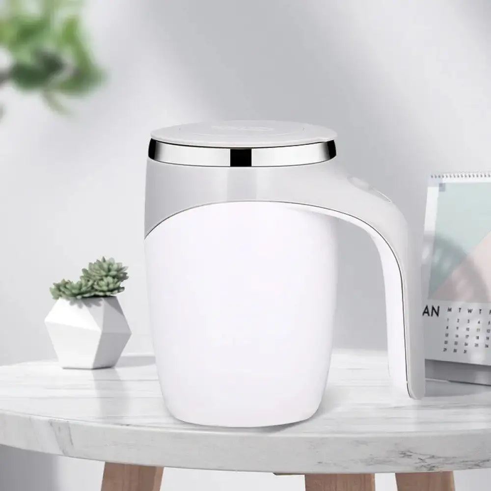 White ceramic electric self stirring coffee mug with sleek silver lid and handle featuring usb charging functionality