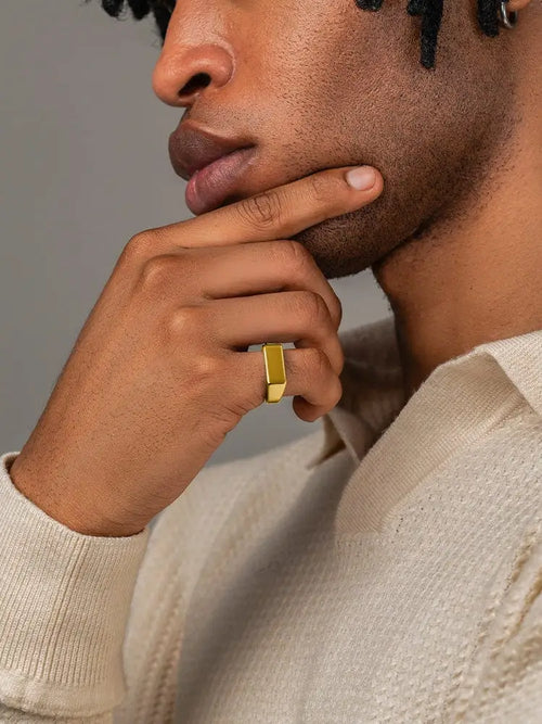 18k gold plated rectangle signet ring for men with a sleek minimalist design worn on the model’s finger
