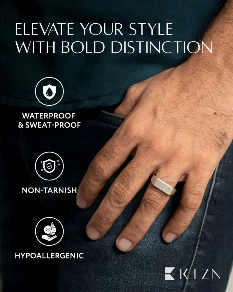 A sleek silver-toned rectangular oxidized 316l stainless steel signet ring with a modern design
