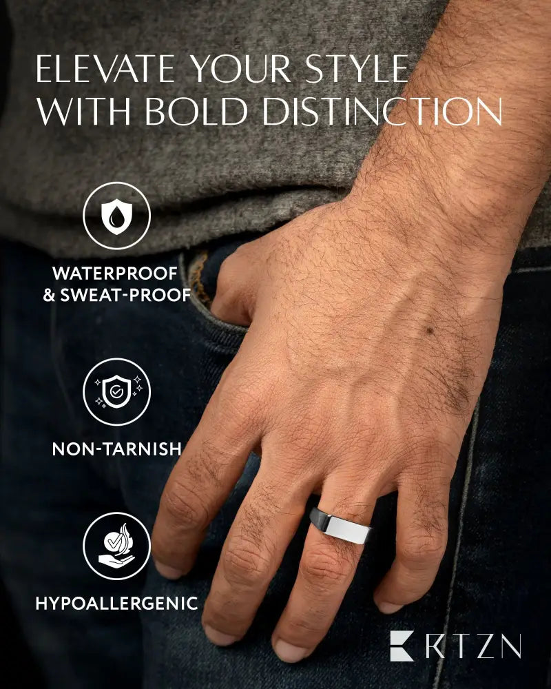 A polished silver rectangle stainless steel signet ring with a sleek minimalist design worn on the middle finger