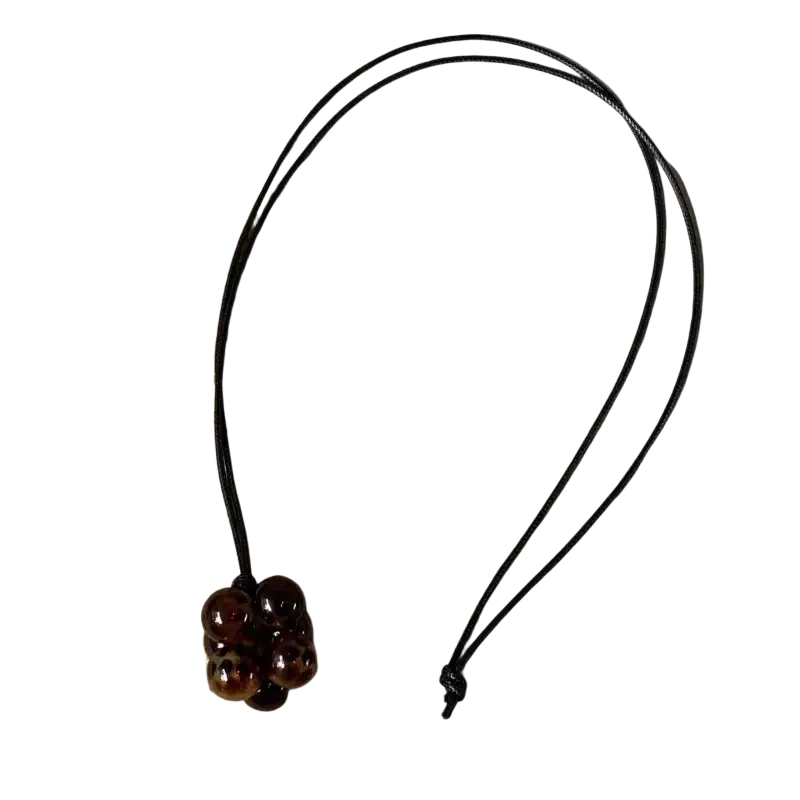 Red bead cluster pendant necklace with polished dark brown beads and amber-like inclusions on black cord