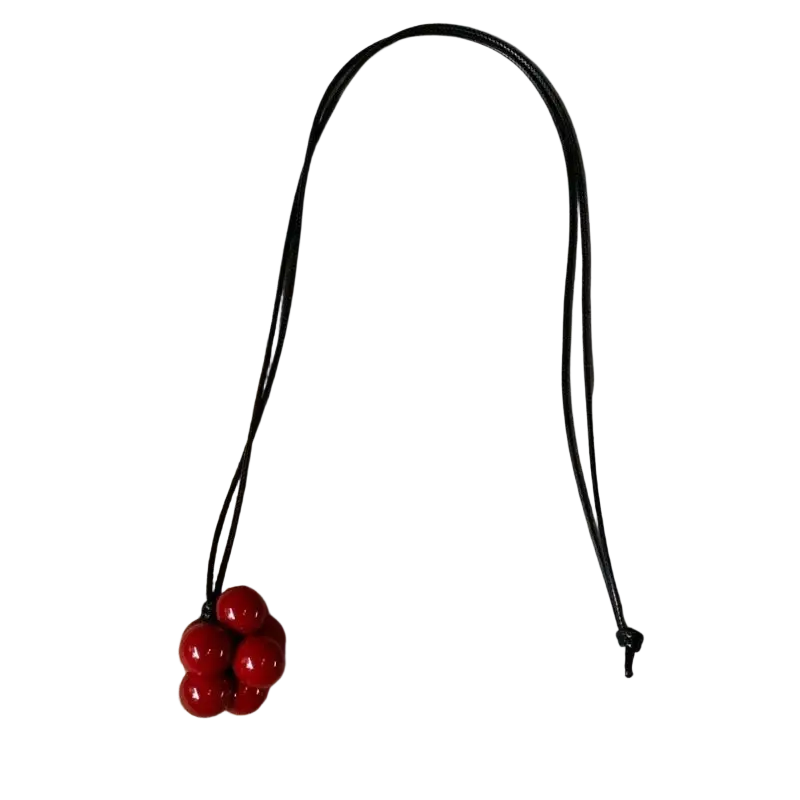Black cord necklace featuring a cluster of glossy red beads in a red bead cluster pendant necklace design