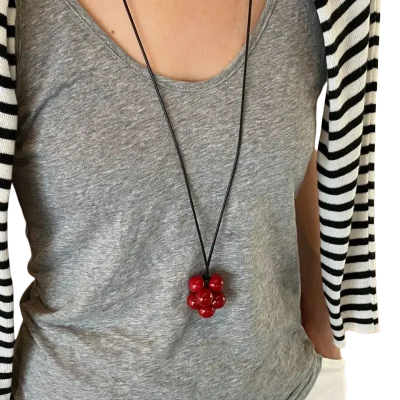 Red bead cluster pendant necklace featuring glossy red glass beads on a black cord for elegant wear