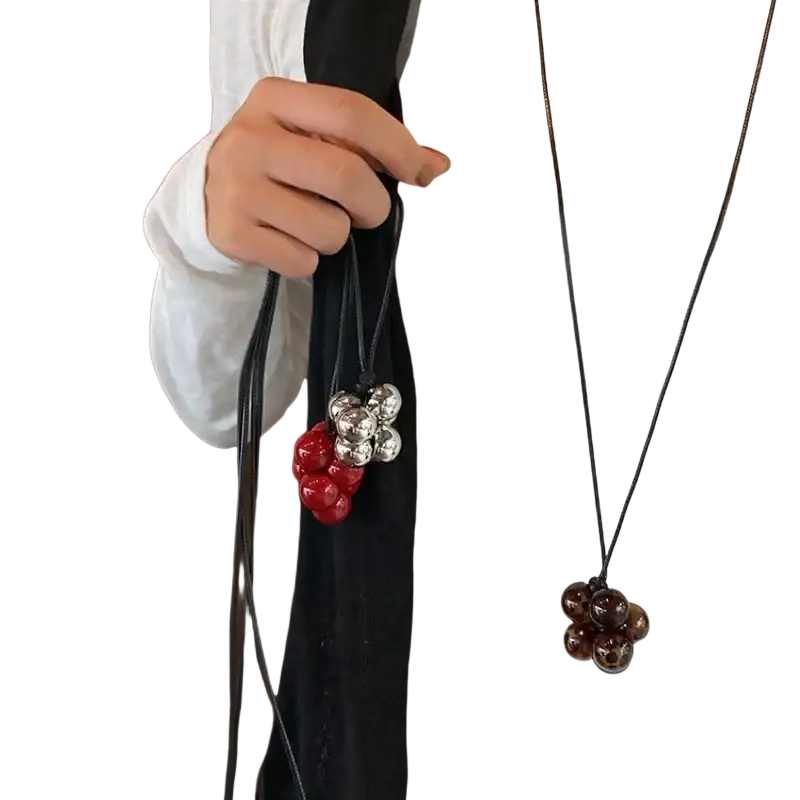 Red bead cluster pendant necklace with silver accents on a black cord for elegant everyday wear