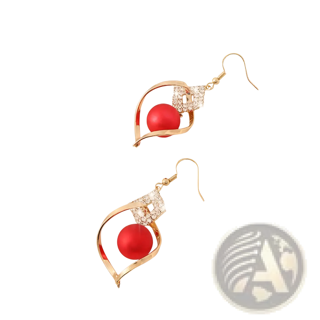 Gold-toned dangle earrings with a vibrant red bead in an open swirling frame adorned with clear crystals