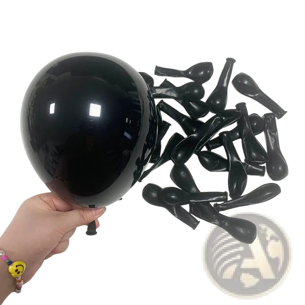 A glossy black latex balloon held in hand with deflated balloons for red black white balloon set party decor