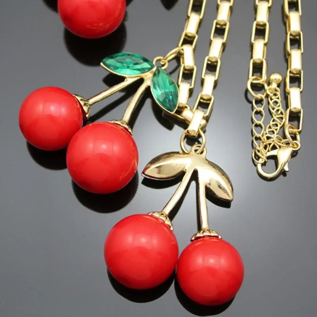 Gold-toned chain necklace with vibrant red enamel cherry pendants and green crystal leaves crystal choker statement necklace