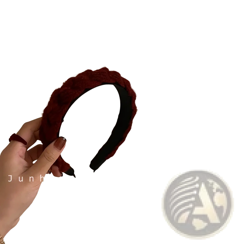 A deep red knitted headband for women with a plush braided design and a soft textured knit exterior