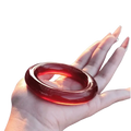 Red jade bangle bracelet for women with glossy deep red jade and smooth polished surface featuring subtle marbling