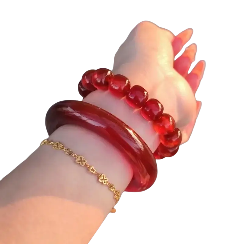 A glossy deep red jade bangle bracelet for women in classic round style worn on a wrist