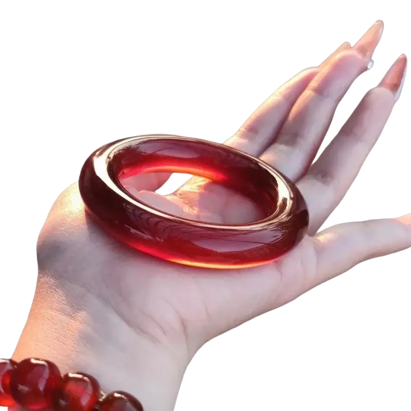 Red jade bangle bracelet for women featuring a translucent deep red polished surface with subtle internal swirls
