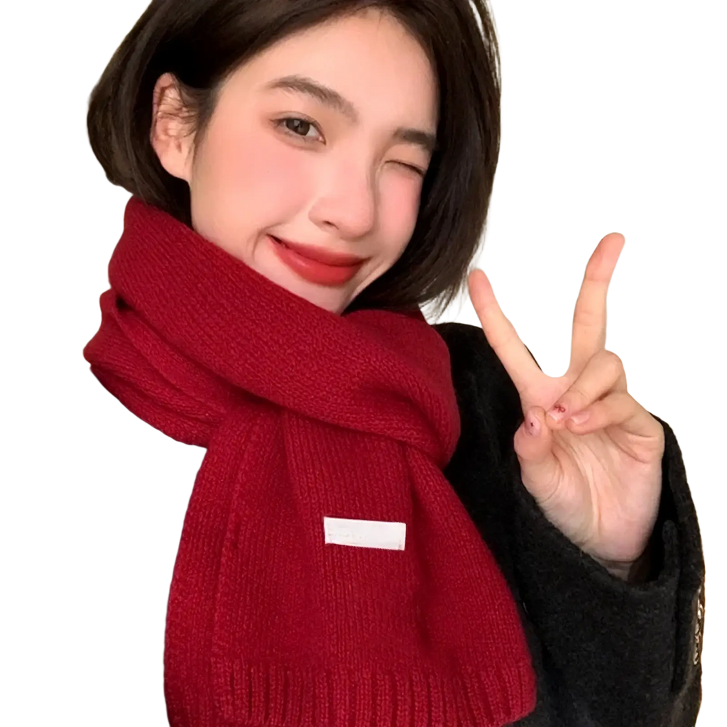 A cozy deep red knitted winter scarf for men and women with a subtle white rectangular patch on the front