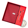 Red leather corporate gift set notebook with silver clasp and matching red textured signature pen in a gift box