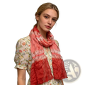 A red metallic skinny long scarf with a soft coral and pink gradient ruffled layered design worn around the neck