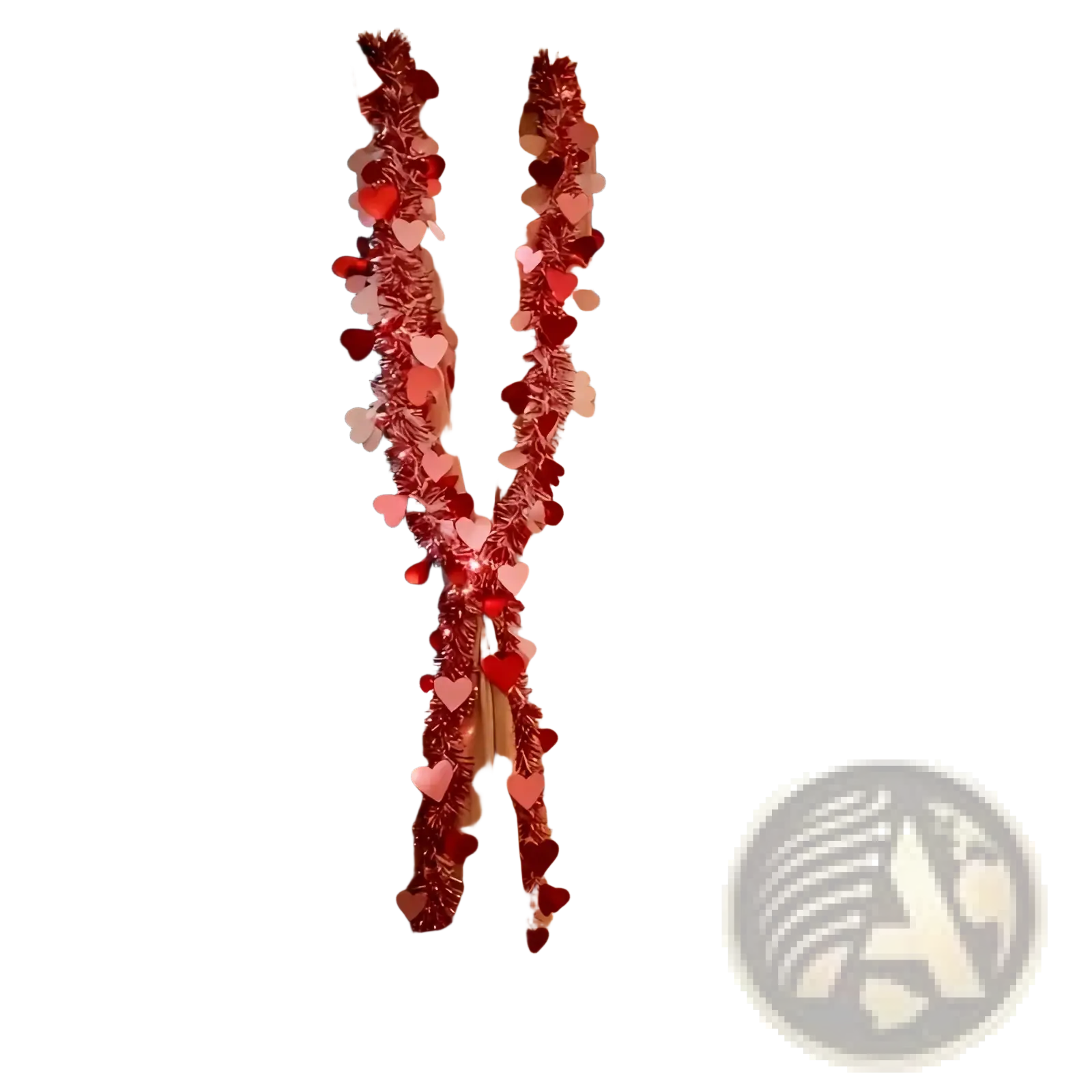 A red and pink metallic heart tinsel garland with festive heart decorations draped on window curtains for Valentine decor