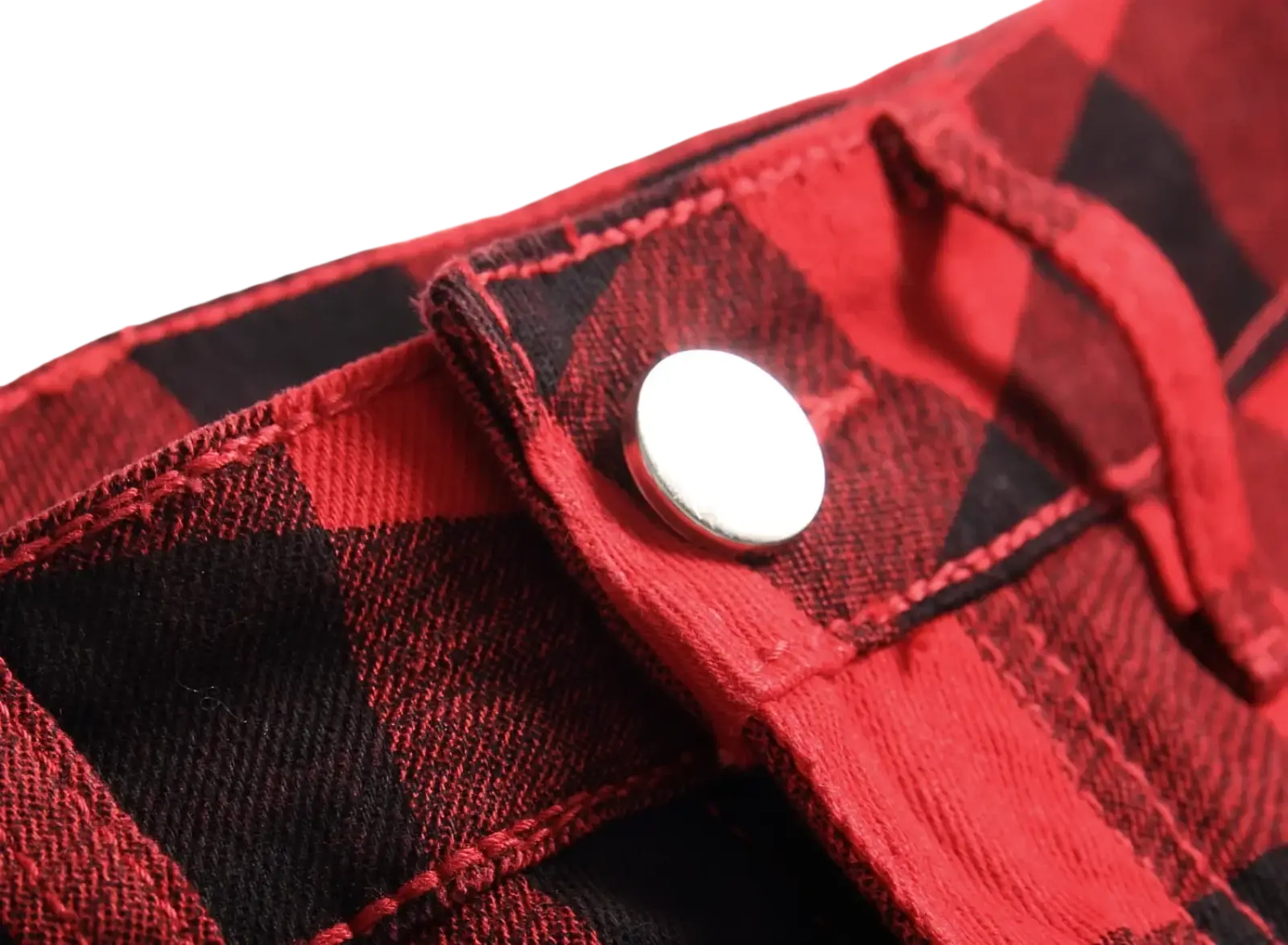 Red plaid slim fit denim jeans featuring red and black plaid fabric with a silver button closure