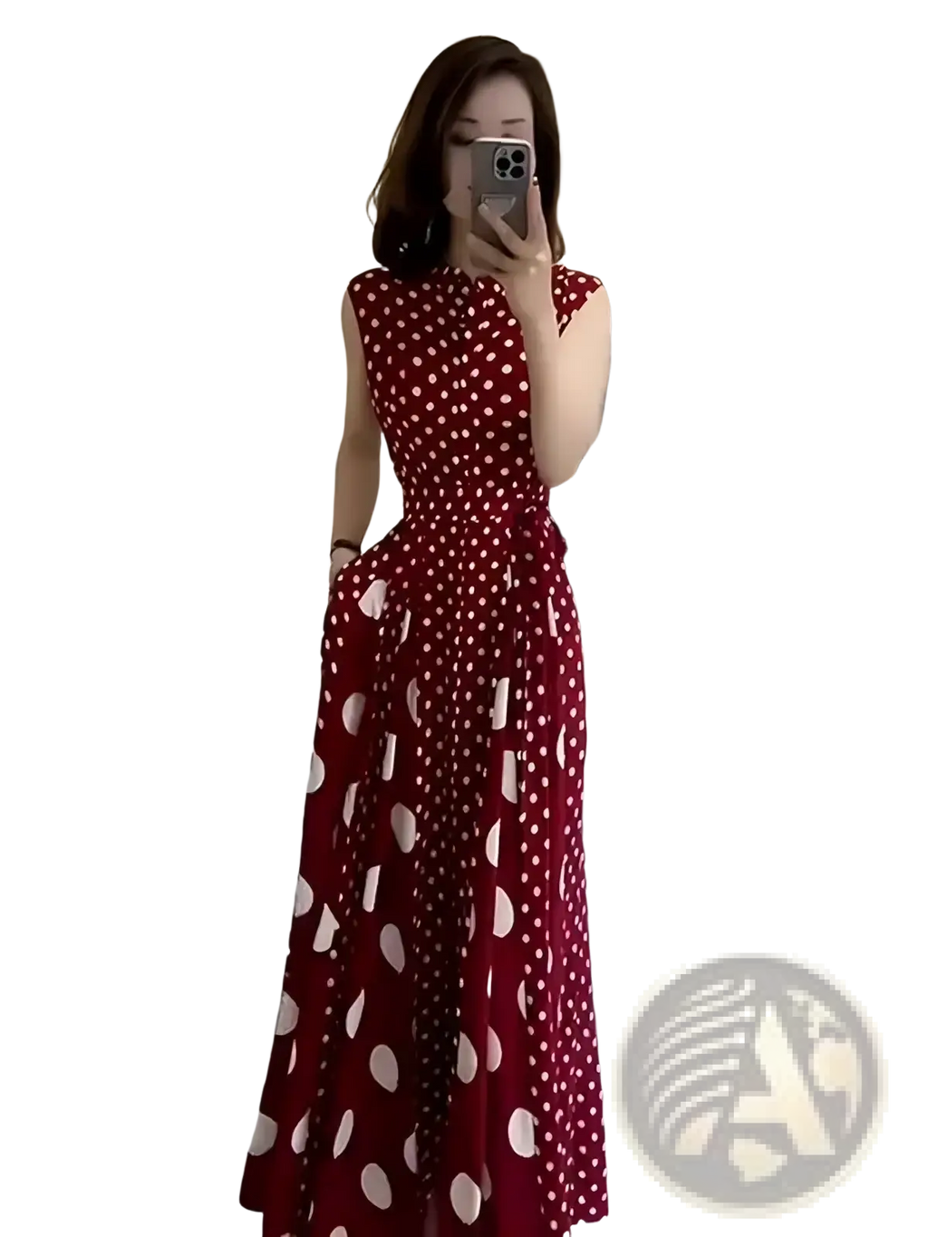 A woman wearing a red and white polka dot sleeveless maxi dress with fitted bodice and flared skirt