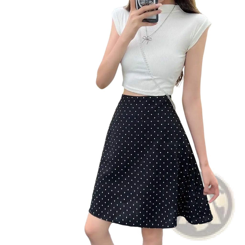 Black skirt with white polka dots featuring an a-line midi design suitable for casual or formal wear