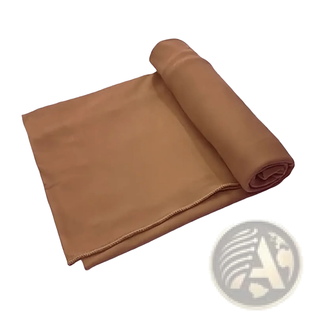 Tan fleece blanket with soft plush texture neatly rolled complementing red stretchy turban headwrap for women