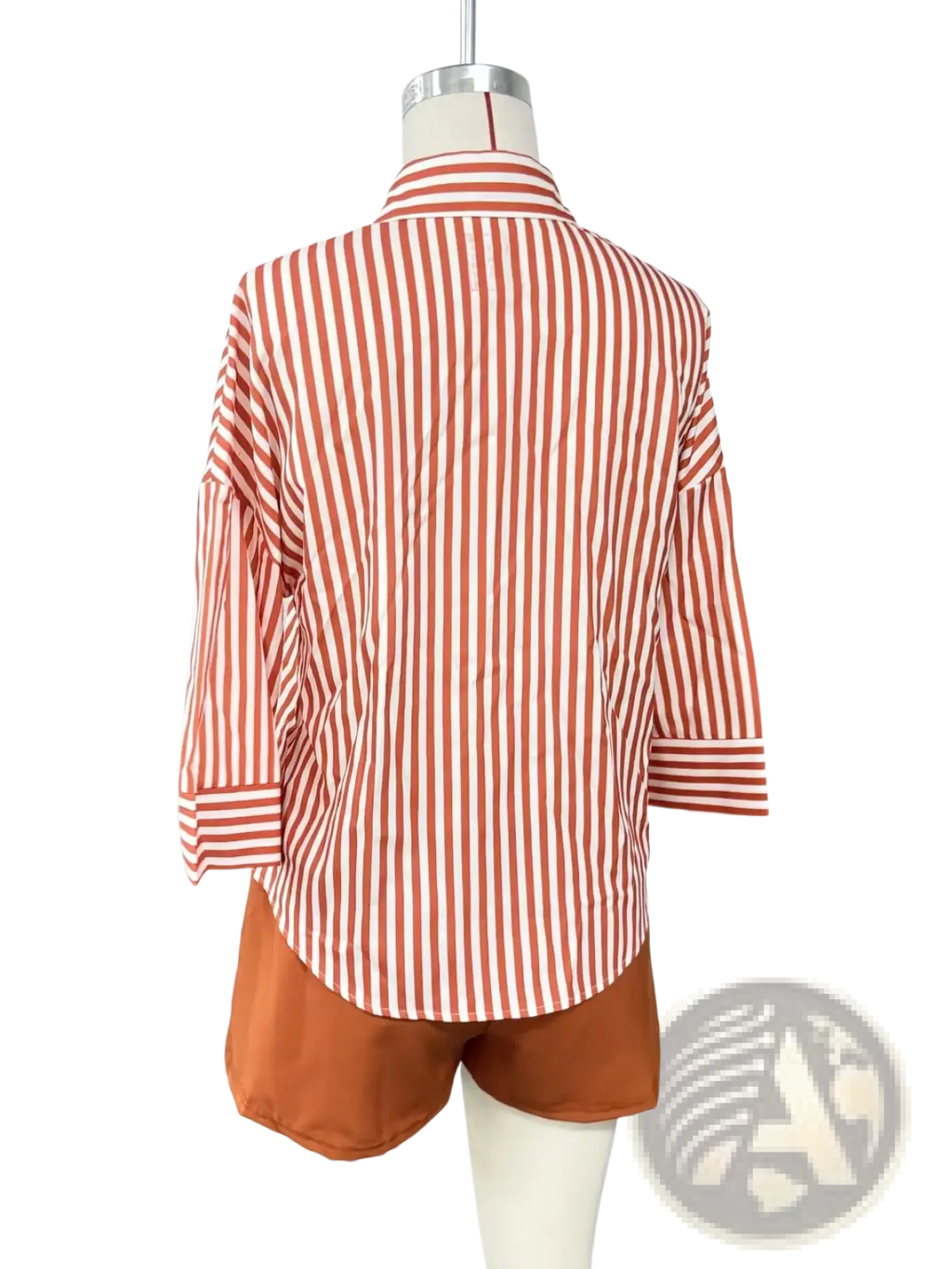 A coral and white vertically striped loose fit button up shirt with three quarter sleeves displayed on a mannequin